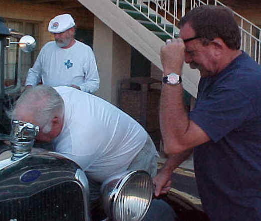 Max, Lyle, and Mark working on Max's car